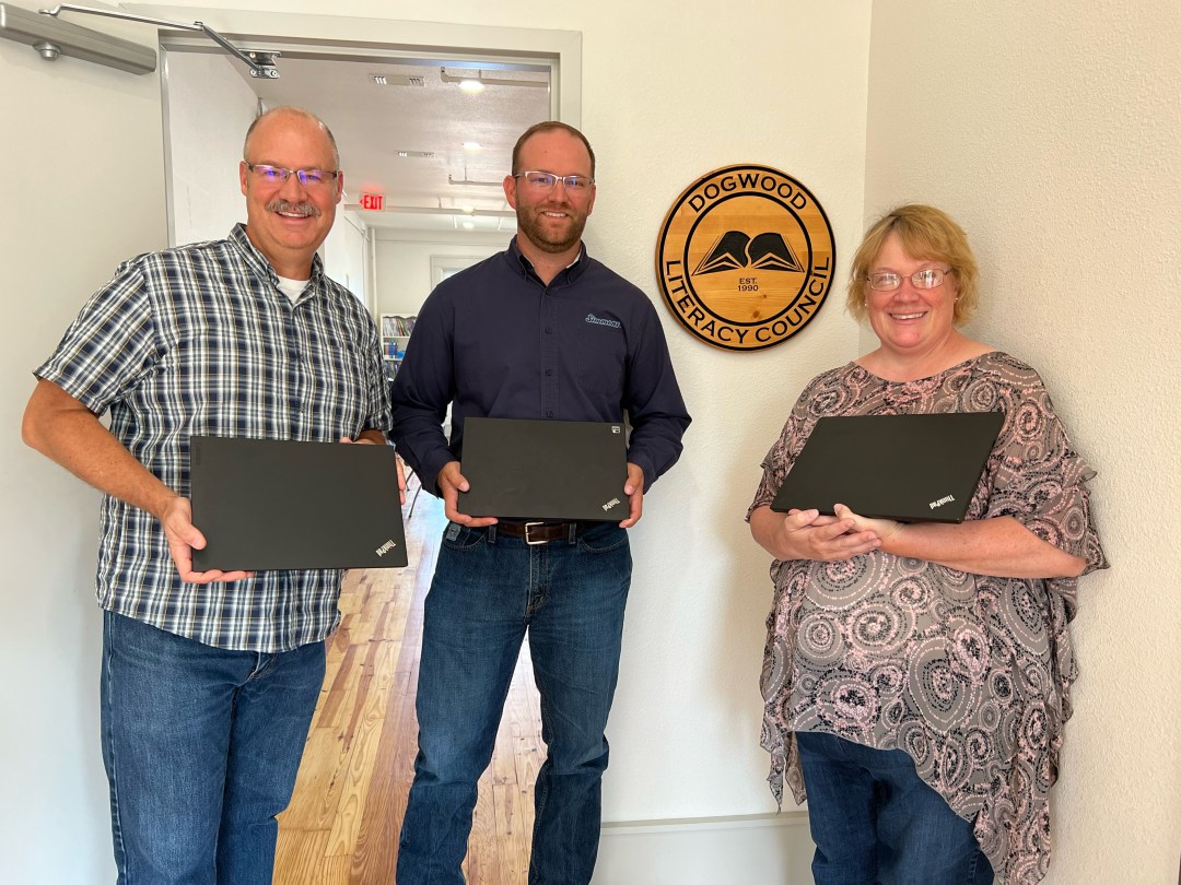 Chris Greathouse (left), Nick Braschler (center) and Charlie Muessemeyer (right) holding three of the laptops in our new building at 325 E. Twin Springs.